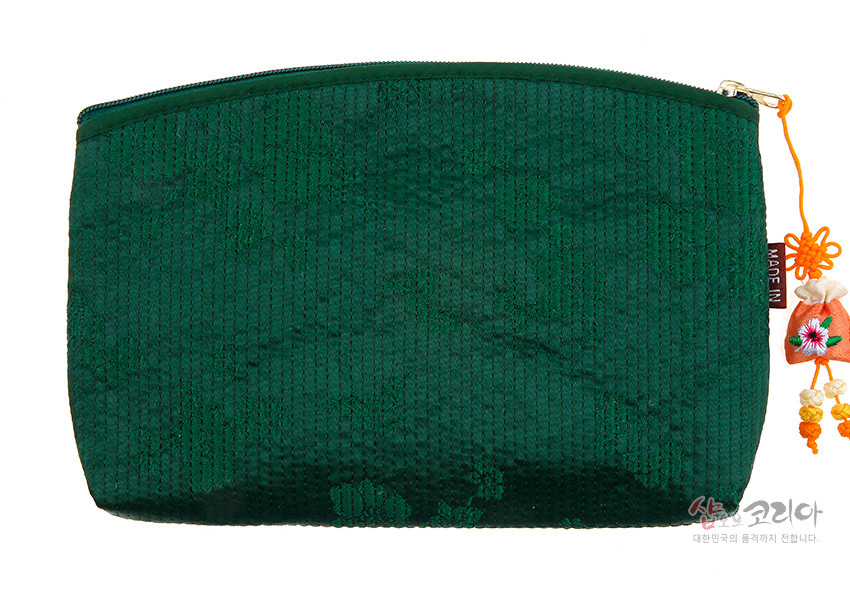 [텍스트: MADE IN] 짙은 녹색 누비 원단 위 은은한 꽃무늬 패턴과 금속 지퍼, 색실 자수 복주머니 매듭 장식이 조화를 이룬 지갑형 파우치 이미지 설명