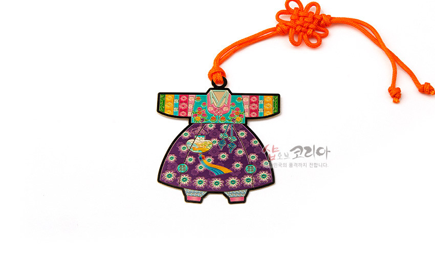 [텍스트: 샵오브코리아] 금속 재질 위 채색 기법으로 표현된 아동 색동한복 모양 책갈피, 보라색 바탕 꽃문양과 원형 전통문양, 노리개 장식, 주황색 매듭끈 장식