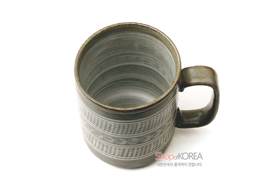 [텍스트: Shop of KOREA 대한민국의 품격까지 전합니다.] 회색 분청도자 표면에 백색 상감 국화문과 점열 문양을 두른 손잡이 머그잔 모습