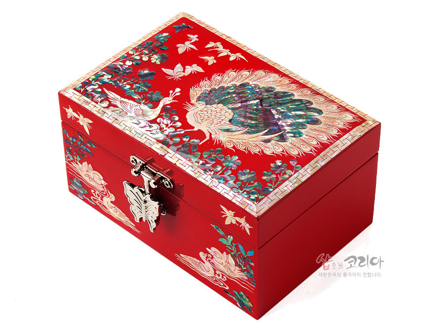 [텍스트: 샵오브코리아 대한민국의 품격까지 전합니다.] 붉은 옻칠 바탕 위 공작과 꽃, 나비 자개 상감과 금속 나비 잠금장식이 돋보이는 직사각 나전칠기 보석함 이미지