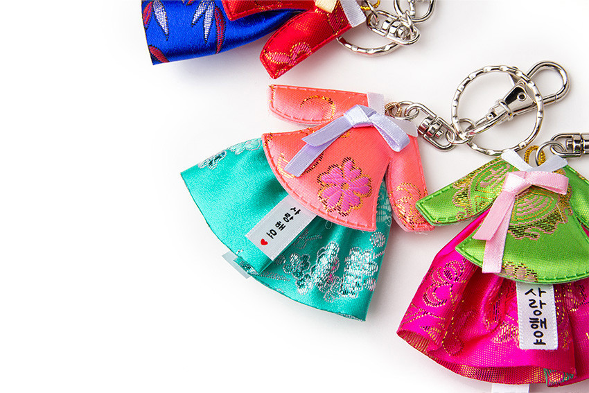 [텍스트: 사랑해요, I ♡ KOREA] 비단 소재 미니 당의 한복 열쇠고리, 금사 짜임의 꽃문양과 나뭇잎 문양, 다양한 선명 색상 대비와 금속 키체인 장식 이미지설명