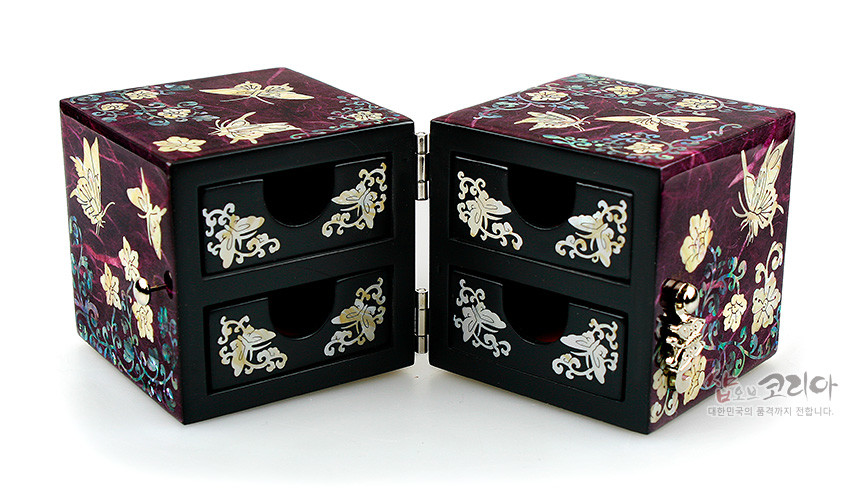 [텍스트: 샵오브코리아 대한민국의 품격까지 전합니다.] 자색 한지 옻칠 바탕 위 자개 상감, 당초넝쿨과 나비 문양으로 장식된 4단 서랍형 쌍합 보석함 구성