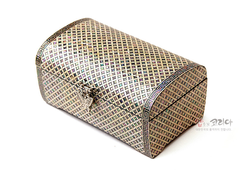 [텍스트: 샵오브코리아 대한민국의 품격까지 전합니다.] 자개 상감 기법으로 촘촘한 격자 전통무늬를 표현하고 가장자리에 기하학 문양과 금속 잠금장식을 더한 돔형 옻칠 보석함 이미지 설명