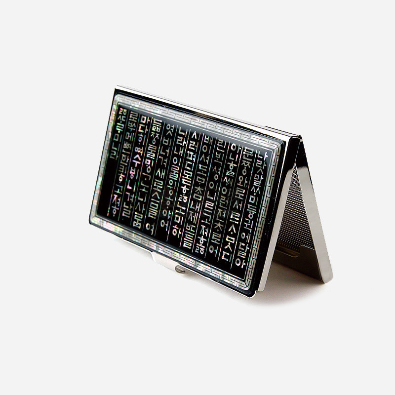 자개 상감 기법으로 한글 훈민정음 글자를 새기고, 검은 바탕과 은색 금속 테두리가 조화를 이루는 명함집.