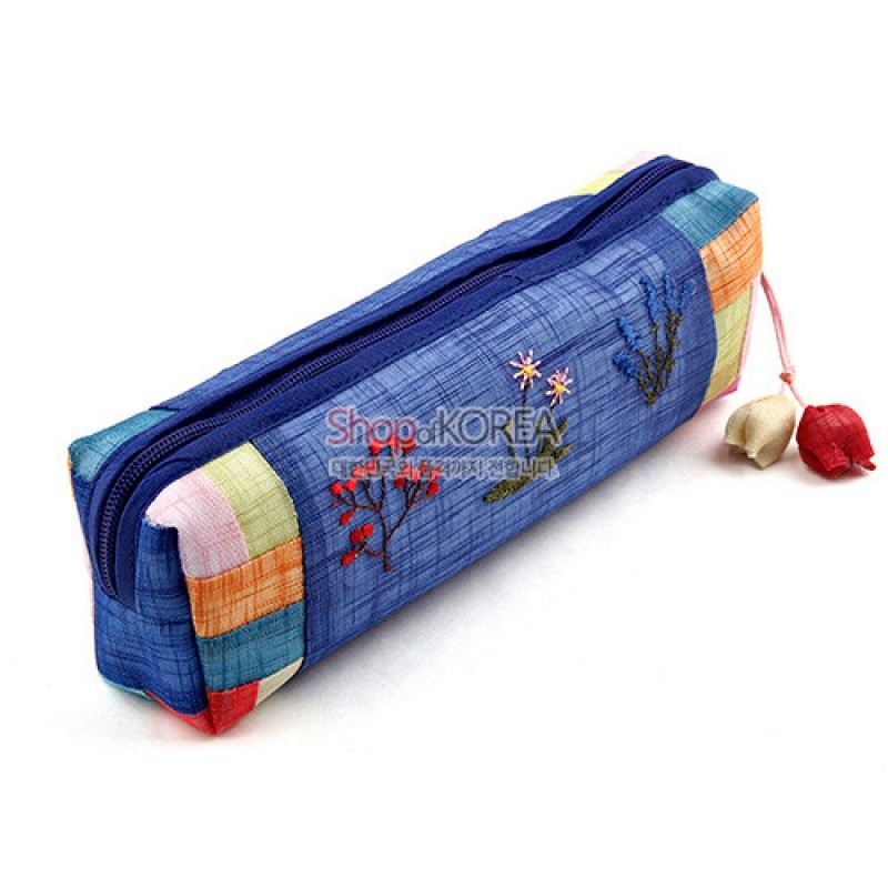 청색 모시 원단 위 꽃자수와 양쪽에 색동천 패치work, 끝부분 꽃 모양 매듭 장식이 돋보이는 필통. 청색 모시 원단 위 꽃자수와 양쪽에 색동천 패치work, 끝부분 꽃 모양 매듭 장식이 돋보이는 필통.
