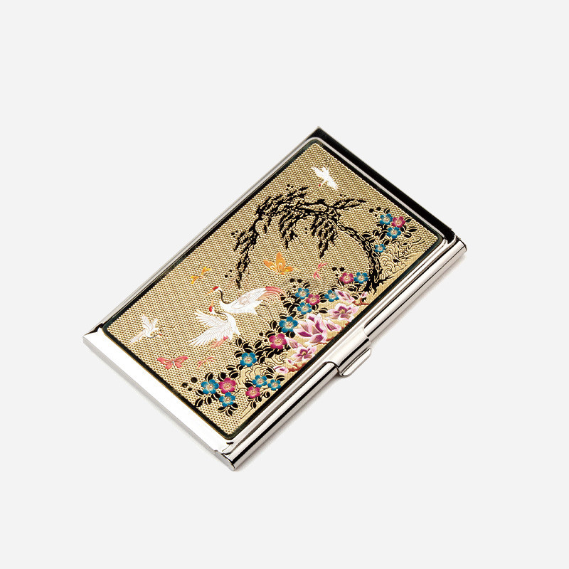 금속 케이스 위 금빛 바탕에 소나무와 학, 꽃과 나비 문양을 섬세한 채색으로 표현한 명함케이스. 금속 케이스 위 금빛 바탕에 소나무와 학, 꽃과 나비 문양을 섬세한 채색으로 표현한 명함케이스.