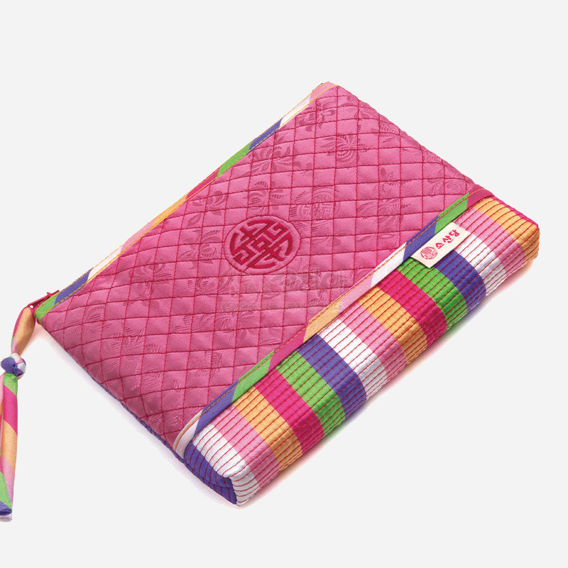 분홍색 누비 비단 바탕에 전통 길상문 자수와 다채로운 색동 줄무늬가 어우러진 파우치. 분홍색 누비 비단 바탕에 전통 길상문 자수와 다채로운 색동 줄무늬가 어우러진 파우치.