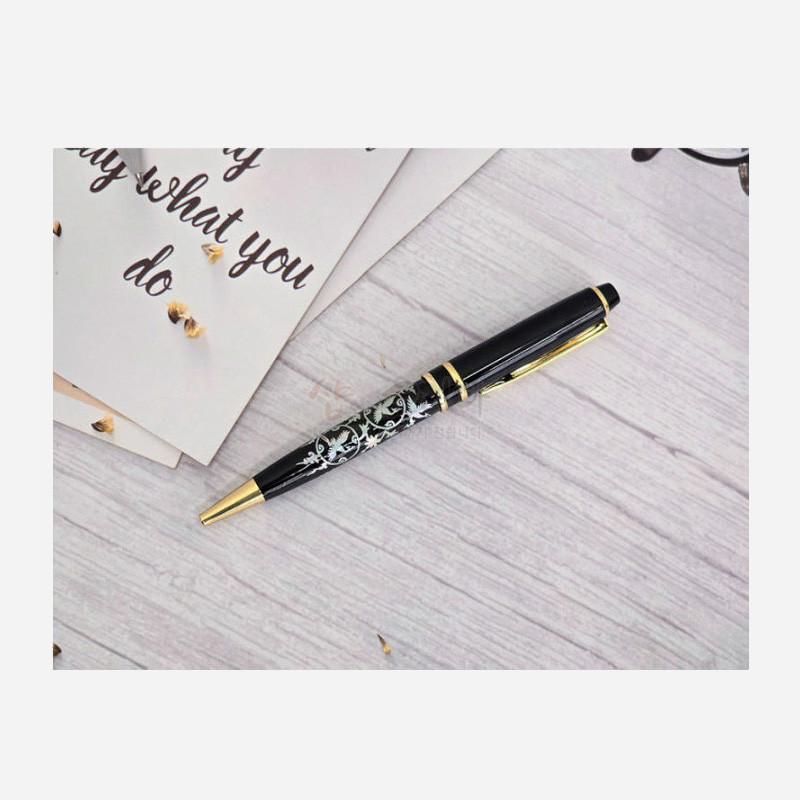 검은색 바디에 금속 장식을 더하고 청자 느낌의 상감 운학문을 새긴 볼펜.