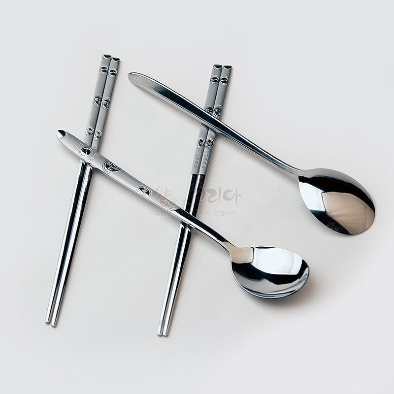 은색 금속 재질의 수저와 젓가락에 엽전 문양이 새겨진 2인용 전통 한국식 수저 세트. 은색 금속 재질의 수저와 젓가락에 엽전 문양이 새겨진 2인용 전통 한국식 수저 세트.