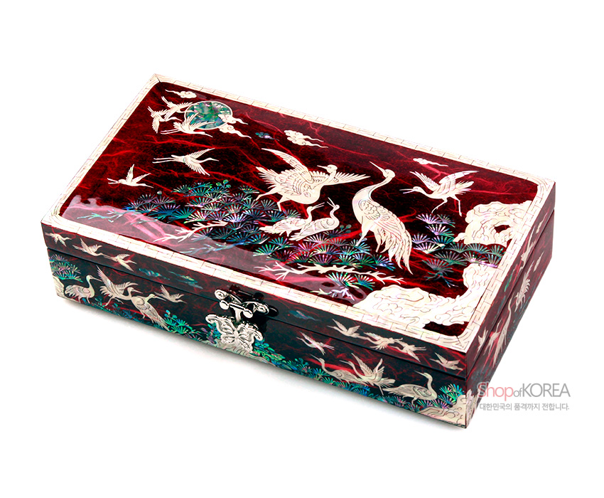 [텍스트: shopofKOREA 대한민국의 품격까지 전합니다.] 적색 한지 바탕 위 자개 상감 기법으로 송학과 소나무, 구름 문양을 섬세하게 표현한 직사각형 보석함 디자인
