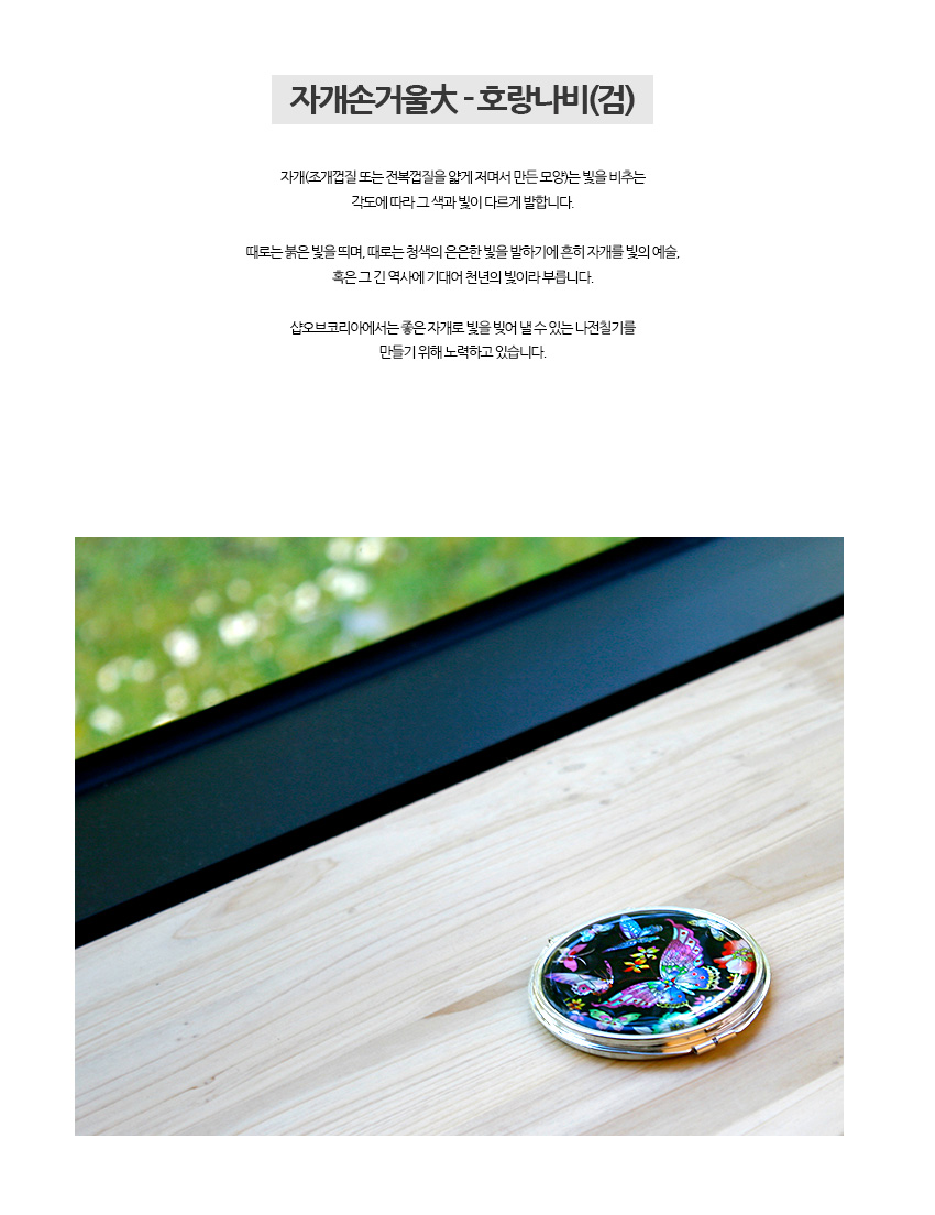 [텍스트: 자개손거울大 - 호랑나비(검)] 검은 옻칠 바탕 위 자개 상감으로 형형색색 호랑나비와 꽃문양을 넣은 금속 테두리 원형 손거울 이미지 설명