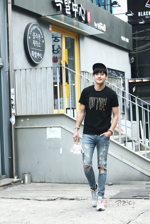 [텍스트: 족발중심, 콜라겐팩토리 족발중심, 샵오브코리아] 검은색 면 티셔츠 위에 금색 훈민정음 서체를 세로 배열로 입체 발포 처리한 현대적인 한글 문양 디자인