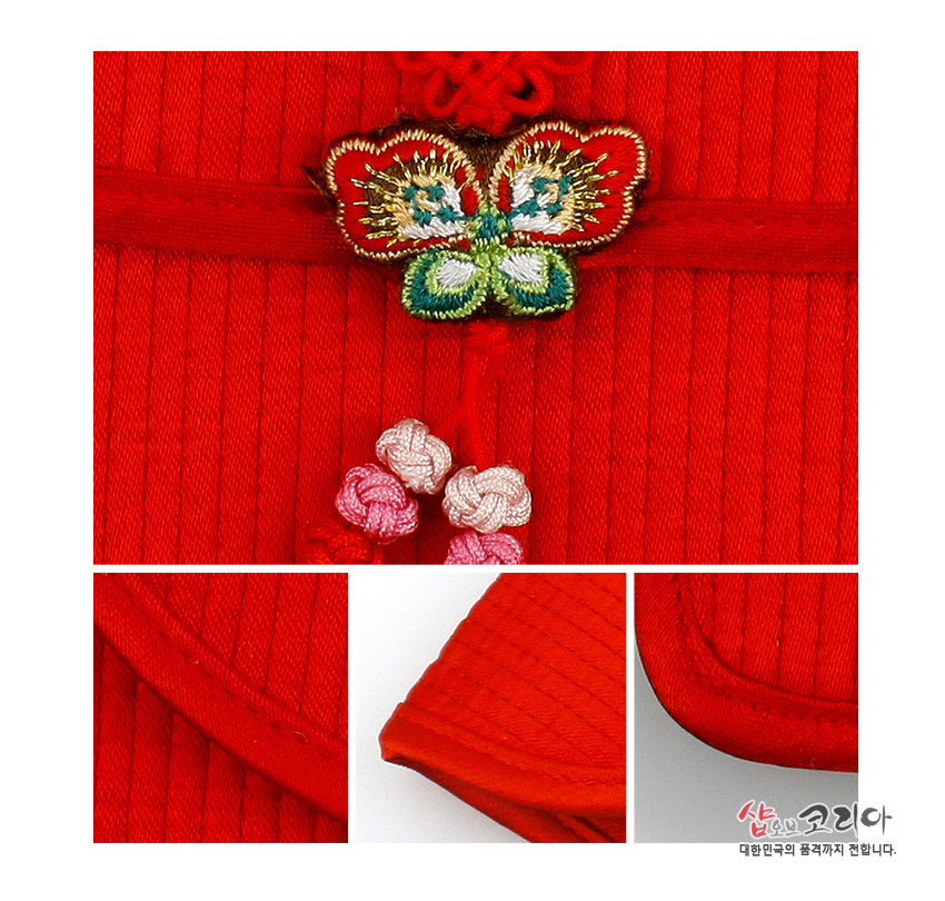 [텍스트: 샵오브코리아 대한민국의 품격까지 전합니다.] 붉은색 세로누빔 천으로 제작된 지갑, 중앙에 다채로운 실과 금사로 수놓은 나비 자수매듭과 분홍·백색 꽃매듭 장식, 가장자리 곡선 마감 누비선 디테일 강조된 구성
