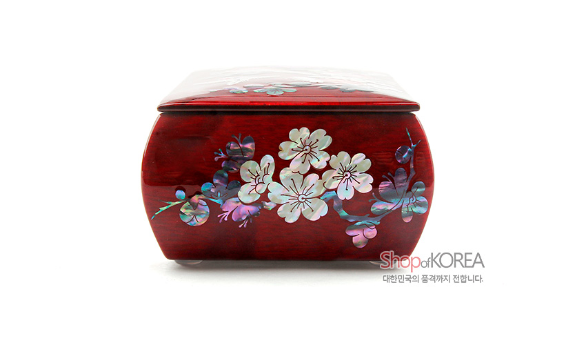 [텍스트: ShopofKOREA 대한민국의 품격까지 전합니다.] 붉은 옻칠 나무 위 자개 상감 기법으로 매화와 꽃문양을 화려하게 장식한 반지꽂이함