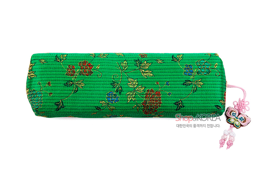 [텍스트: Shop of KOREA 대한민국의 품격까지 전합니다.] 녹색 누비 천에 금사로 수놓은 꽃과 나뭇가지 문양, 옆면 분홍색 나비 매듭 장식이 더해진 원통형 필통 모습