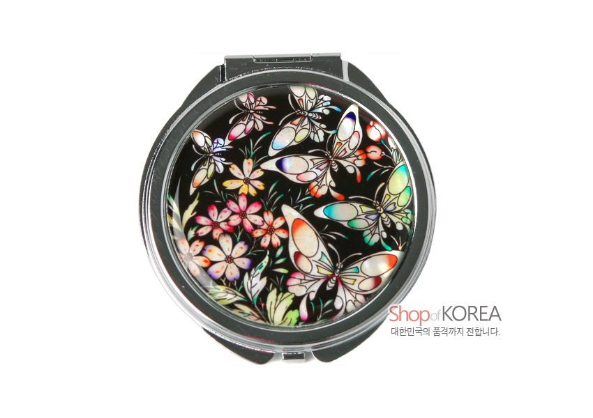 [텍스트: Shop of KOREA 대한민국의 품격까지 전합니다.] 검은 바탕 금속 손거울 위에 자개 상감 기법으로 표현된 오색 나비와 꽃문양 장식 이미지