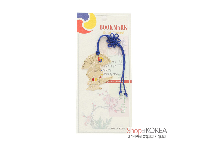 [텍스트: BOOK MARK / Gold Plated / special meet / MADE IN KOREA] 금장 금속으로 표현한 부채춤 인물과 태극 문양 장식, 짙은 파란색 전통 매듭 끈이 조화를 이루는 책갈피 구성