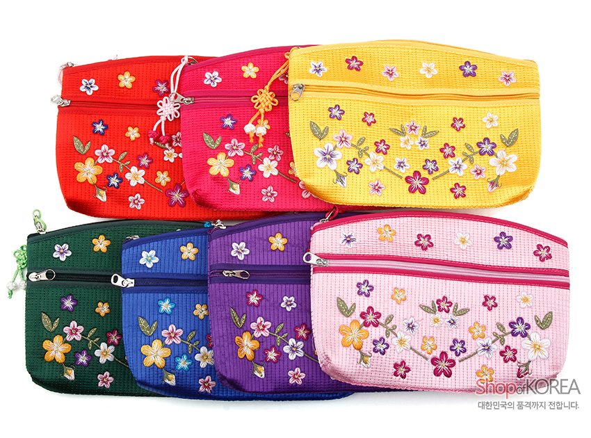 [텍스트: Shop of KOREA 대한민국의 품격까지 전합니다.] 누비 직조 원단 위 다채로운 색실로 수놓은 배꽃과 잎사귀 문양, 지퍼 매듭 장식이 특징인 다색 꽃 자수 파우치 이미지 설명