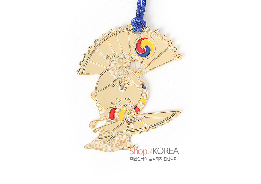 [텍스트: Shop of KOREA 대한민국의 품격까지 전합니다.] 금장 금속으로 제작된 부채춤 인물 책갈피, 태극 삼색 문양과 청색 전통 매듭 끈이 조화를 이룬 디자인