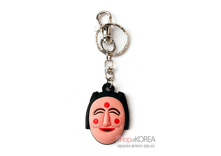[텍스트: Shop of KOREA 대한민국의 품격까지 전합니다.] 실리콘 소재로 입체 표현된 분홍색 하회탈 얼굴 장식과 은색 금속 체인, 고리로 구성된 열쇠고리 디자인