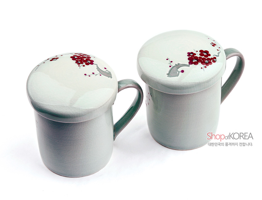 [텍스트: ShopofKOREA 대한민국의 품격까지 전합니다.] 옅은 청자빛 유약 위 붉은 매화 문양과 초록손잡이가 조화를 이룬 도자기 뚜껑 머그컵 2인 세트 이미지