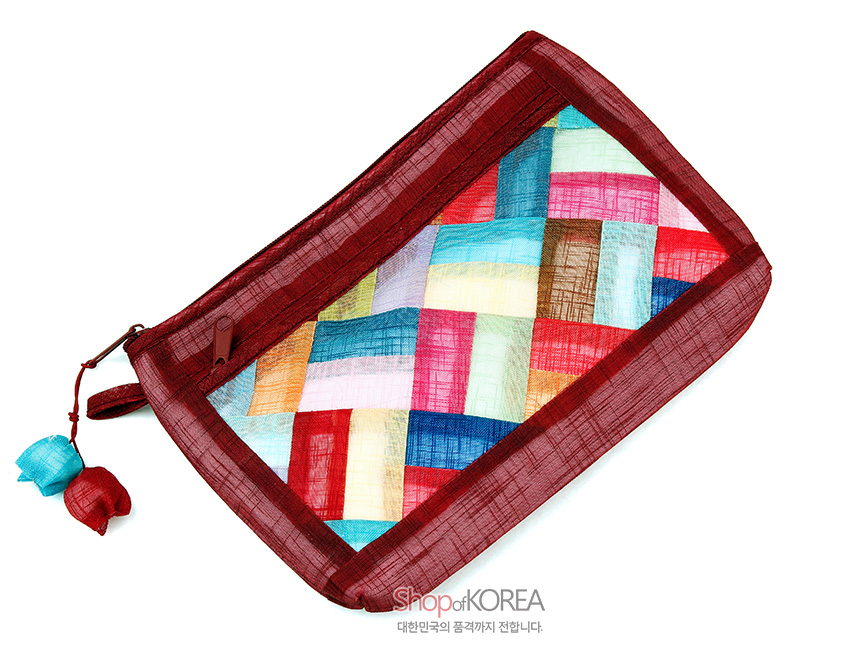 [텍스트: Shop of KOREA 대한민국의 품격까지 전합니다.] 적갈색 모시 테두리에 다양한 색 모시 조각을 전통 조각보 기법으로 사선 배치한 지퍼 파우치, 청홍색 실크 매듭 장식 포인트 디자인