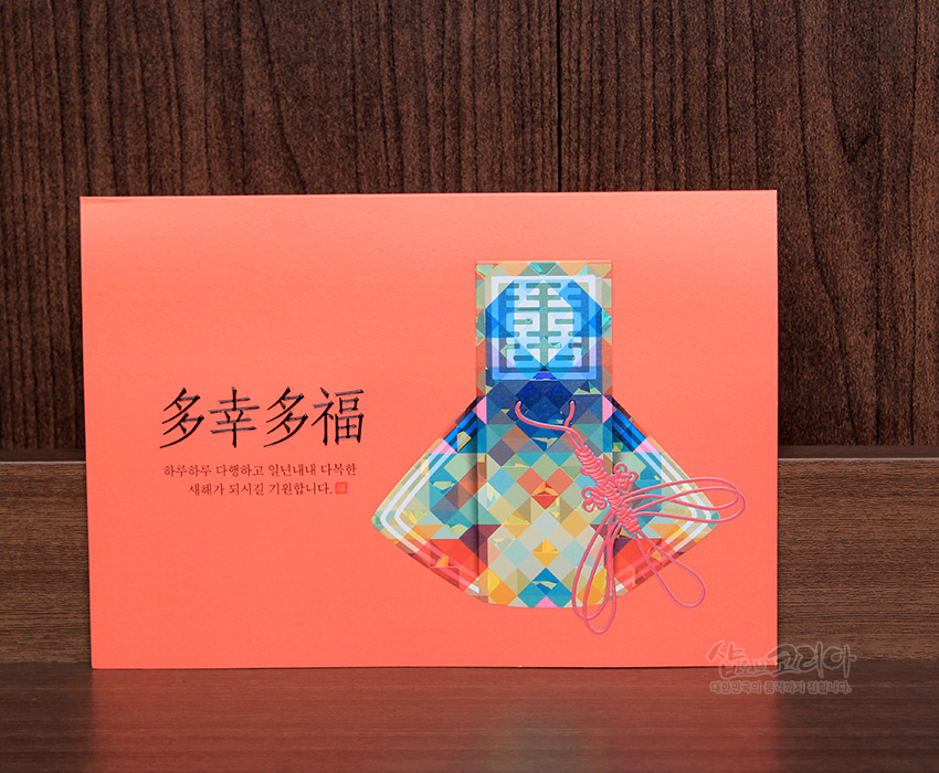 [텍스트: 多幸多福 하루하루 다행하고 일년내내 다복한 새해가 되시길 기원합니다.] 다채로운 기하학 패턴 복주머니와 전통 매듭장식이 돋보이는 한자 복 문자 연하장 디자인