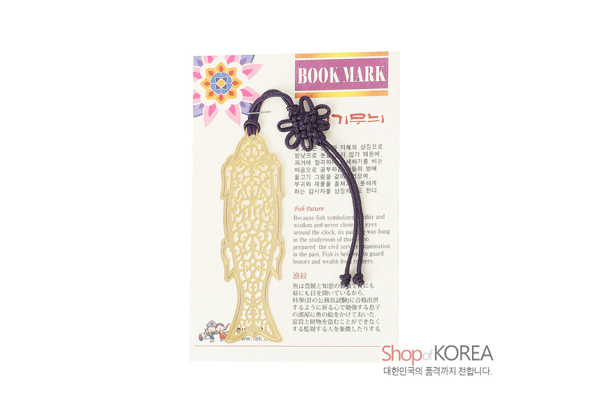 [텍스트: BOOK MARK, Shop of KOREA 대한민국의 품격까지 전합니다.] 금장 금속 소재 물고기 형태 투각 문양 책갈피와 진한 보라색 전통 매듭 장식의 조화로운 구성