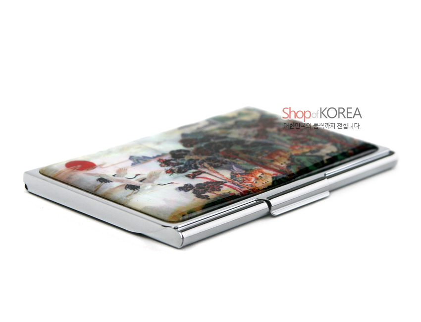 [텍스트: Shop of KOREA 대한민국의 품격까지 전합니다.] 금속 테두리에 자개 상감으로 십장생 민화 산수와 해·학·소나무를 다채로운 색으로 표현한 명함집 디자인