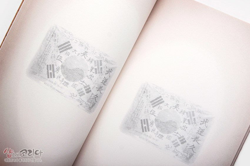 [텍스트: 샵오브코리아 대한민국의 품격까지 전합니다.] 내지에 연한 베이지색 그라데이션 바탕과 태극기 및 한자 문양을 흐릿하게 인쇄한 디자인의 전통 느낌 노트 페이지 이미지