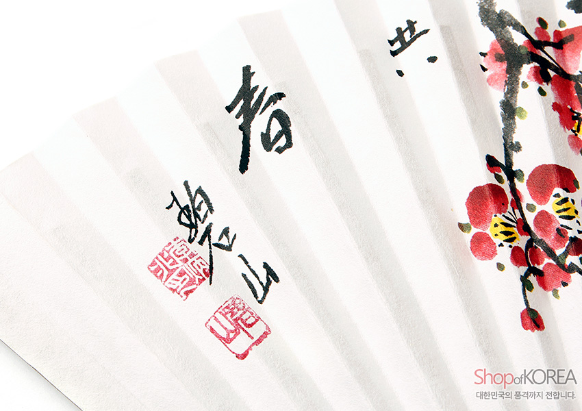 [텍스트: 春 碧山 Shop of KOREA 대한민국의 품격까지 전합니다.] 흰 종이 접선 위 수묵 매화 가지와 붉은 매화꽃, 검은 서예와 붉은 낙관이 어우러진 전통 부채 디자인