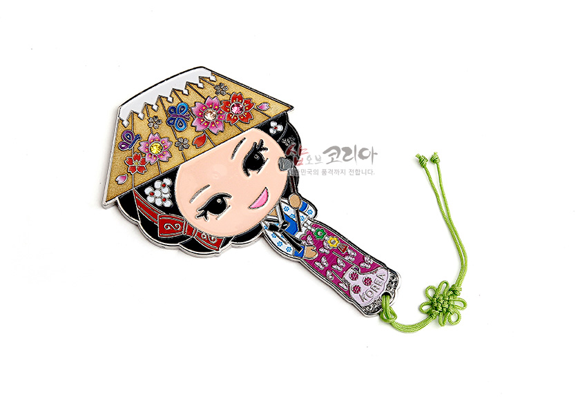 [텍스트: KOREA] 금속 재질에 채색 기법으로 표현된 한복 어우동 캐릭터 손거울, 모자와 한복에 꽃문양 장식, 연두색 매듭끈 포인트 디자인