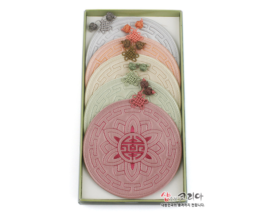 [텍스트: 샵오브코리아 대한민국의 품격까지 전합니다.] 전통 누비 기법의 연꽃·수복문 자수 원형 컵받침 세트, 파스텔톤 비단 소재와 오방색 매듭 장식 특징