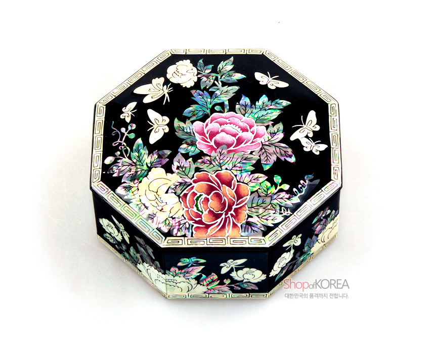 [텍스트: ShopofKOREA 대한민국의 품격까지 전합니다.] 흑색 옻칠 바탕에 자개 상감으로 목단꽃과 나비 문양을 정교하게 수놓은 팔각 보석함 디자인