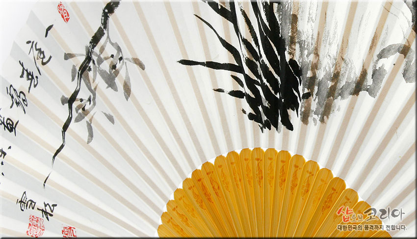 [텍스트: 샵오브코리아 대한민국의 품격까지 전합니다.] 흰 한지 위 수묵 난초와 서예, 붉은 낙관, 연노랑 대나무 살대가 어우러진 합죽선 클로즈업 이미지