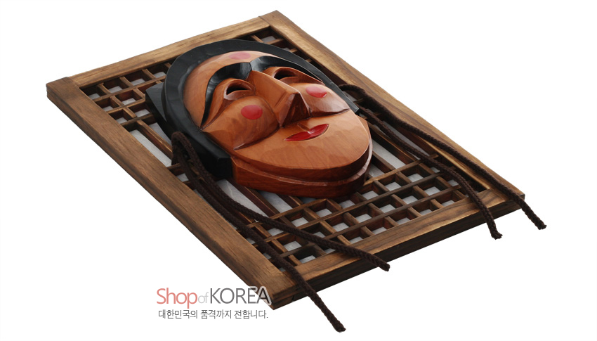 [텍스트: Shop of KOREA / 대한민국의 품격까지 전합니다.] 나뭇결 살린 갈색 목재 문창살 위 부네 하회탈 입체 부조, 흑색과 적색 포인트 대비가 돋보이는 전통 목공예 장식