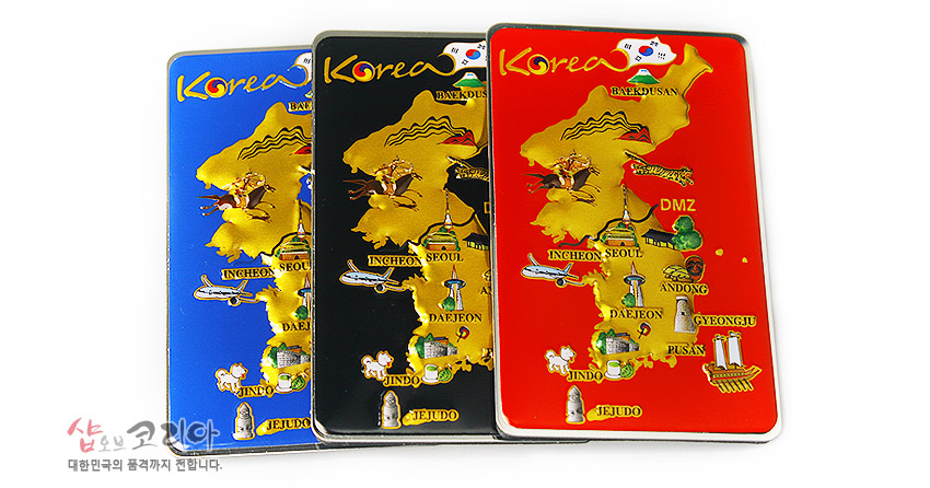 [텍스트: Korea, BAEKDU, DMZ, INCHEON, SEOUL, DAEJEON, ANDONG, GYERONGJU, PUSAN, JINDO, JEJUDO] 청색·흑색·적색 배경 위 금색 입체 대한민국 지도와 관광지 일러스트, 금속 재질 메모홀더형 자석 디자인