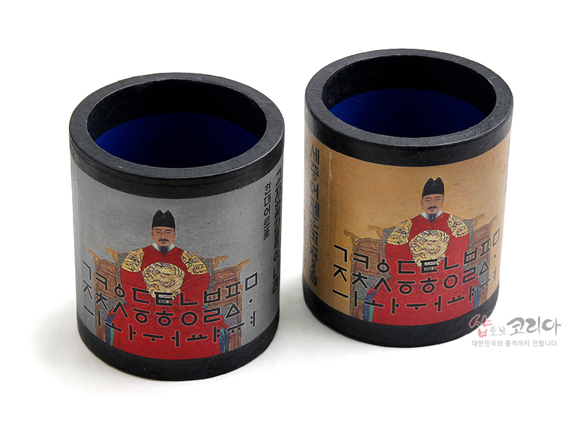 [텍스트: 세종어제훈민정음] 종이 재질 원통형 펜꽂이에 세종대왕 어좌 초상과 훈민정음 서체를 인쇄하고 검정 테두리와 청색 내부로 마감한 전통 디자인 소품