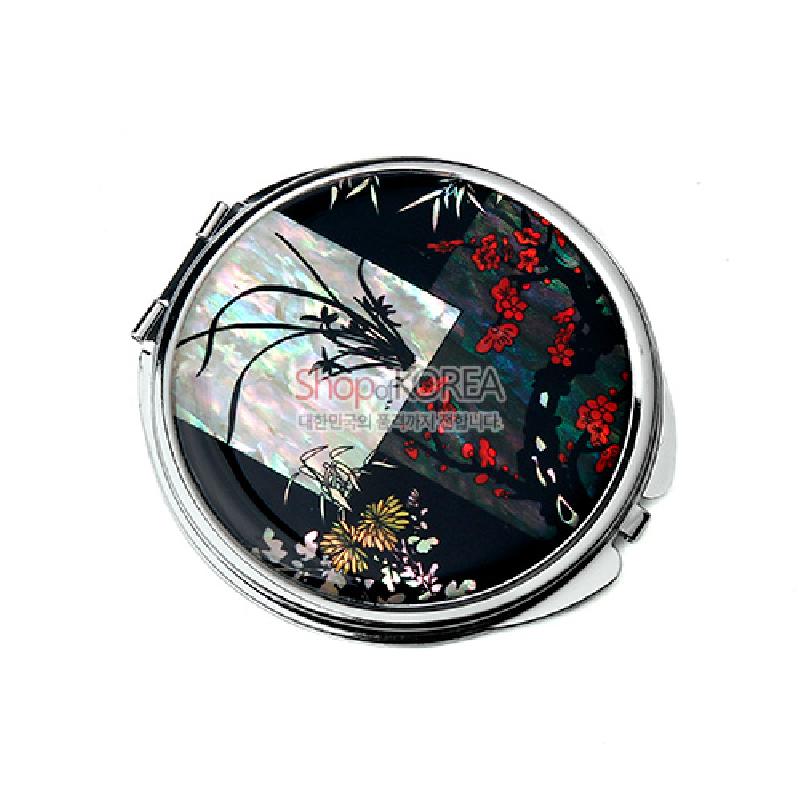 자개 상감 기법으로 난·대·국·매 사군자 문양을 표현한 흑색 배경의 금속 테두리 손거울.