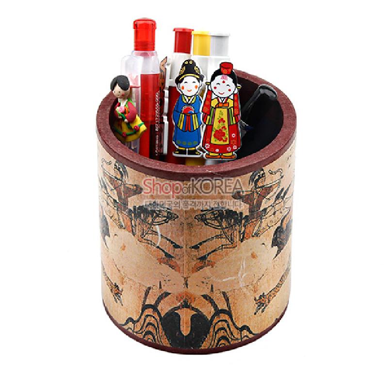 나무 재질에 전통 수렵도 문양을 인쇄한 원통형 연필꽂이, 갈색 톤 배경과 검은 선묘 장식이 특징인 필통.