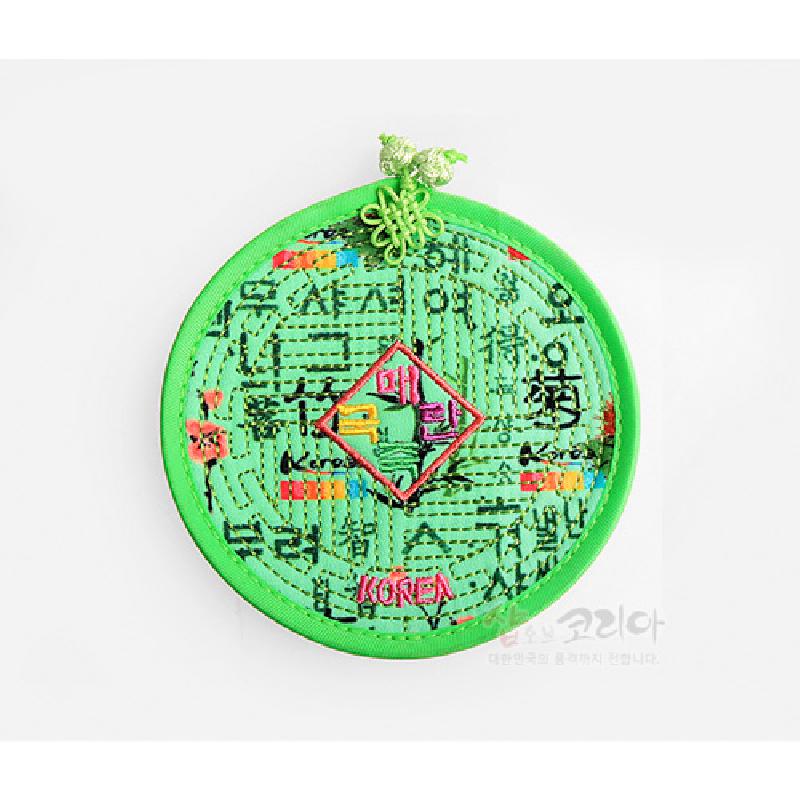 밝은 연두색 천에 누비 기법으로 훈민정음 문자와 색동 자수 문양을 더한 원형 컵받침.