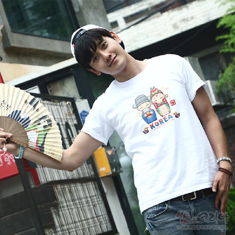 한복 차림 신랑신부 캐릭터와 알록달록 전통문양이 입체발포 기법으로 표현된 흰색 면 반팔 티셔츠.