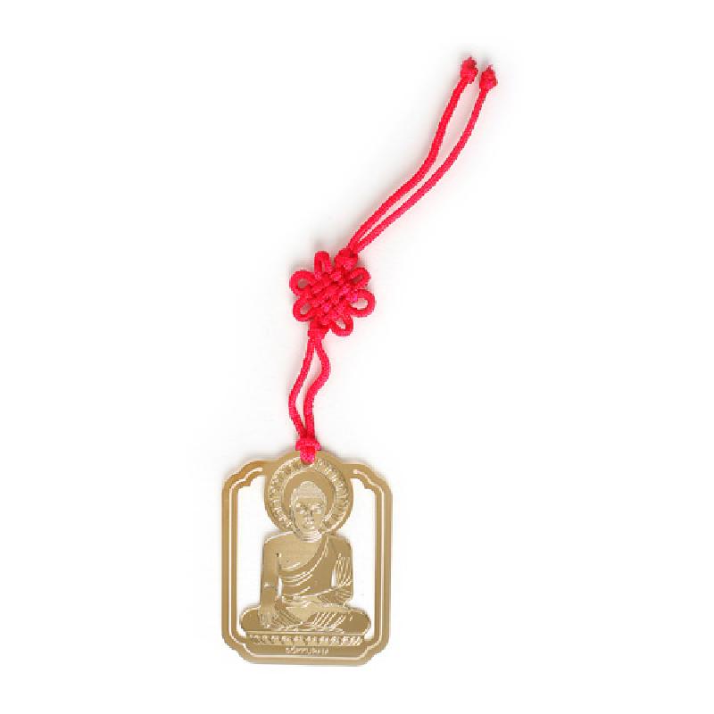 금속 재질에 석굴암 본존불 문양을 양각으로 새긴 금장 책갈피와 붉은 색 전통 매듭 끈 장식. 금속 재질에 석굴암 본존불 문양을 양각으로 새긴 금장 책갈피와 붉은 색 전통 매듭 끈 장식.