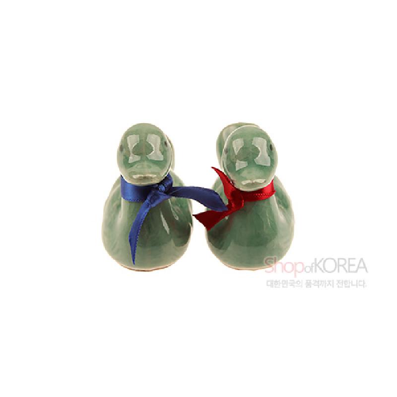 청자 재질의 원앙 형상 수저받침 세트, 유약의 광택과 청록색 조화, 붉은색·파란색 비단 리본 장식.