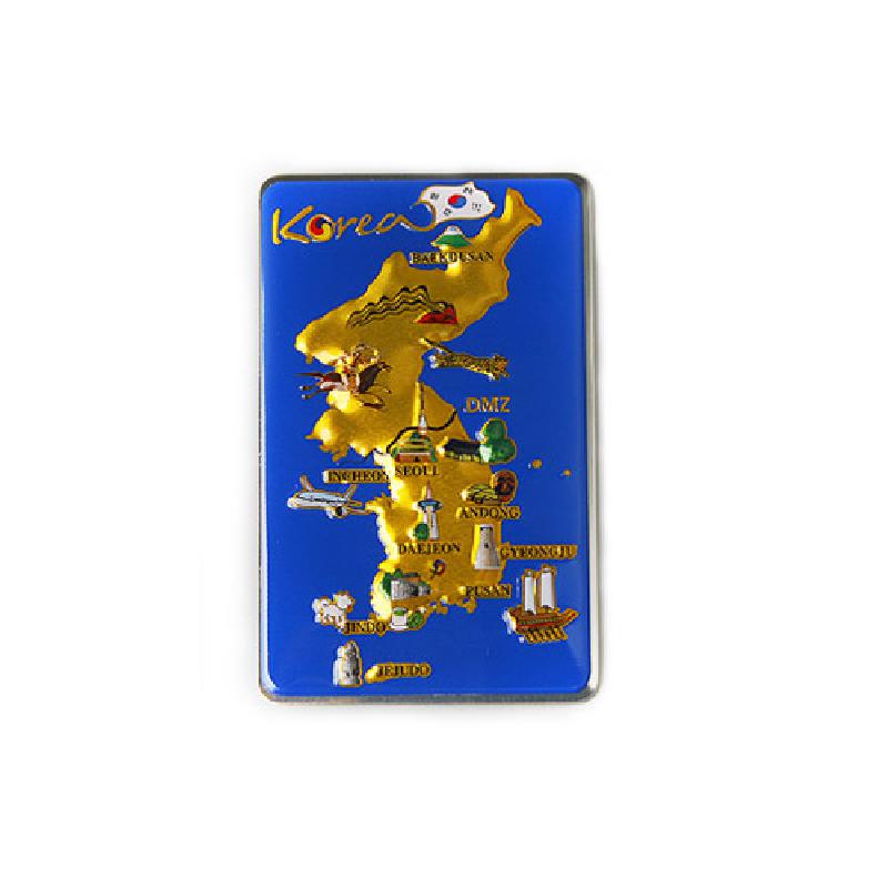 푸른 배경 위에 금색 입체 대한민국 지도를 배치하고 주요 관광지 아이콘을 다채로운 색으로 표현한 금속 메모홀더. 푸른 배경 위에 금색 입체 대한민국 지도를 배치하고 주요 관광지 아이콘을 다채로운 색으로 표현한 금속 메모홀더.