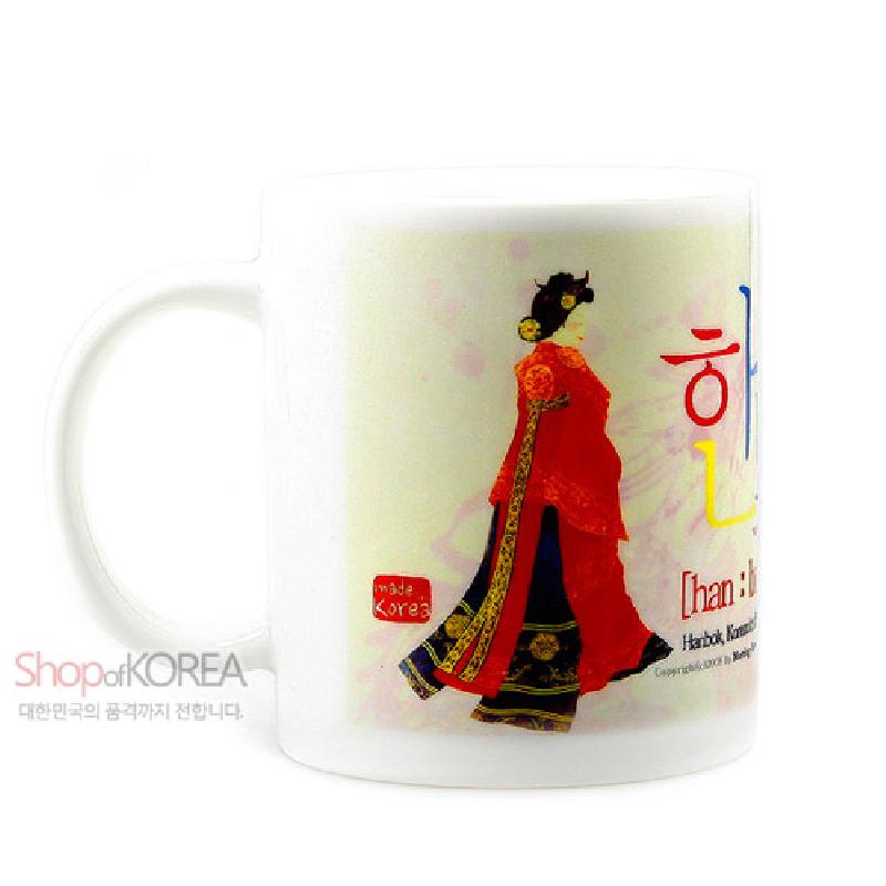 전통 예복을 입은 왕비 일러스트가 인쇄된 도자기 재질의 머그컵, 붉은색과 남색 대비와 금색 장식 문양이 특징인 디자인.