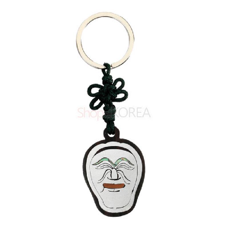 흑단 테두리에 양반탈 얼굴을 새긴 열쇠고리로, 흰색 바탕과 갈색·녹색 포인트, 전통 매듭 장식이 돋보이는 디자인