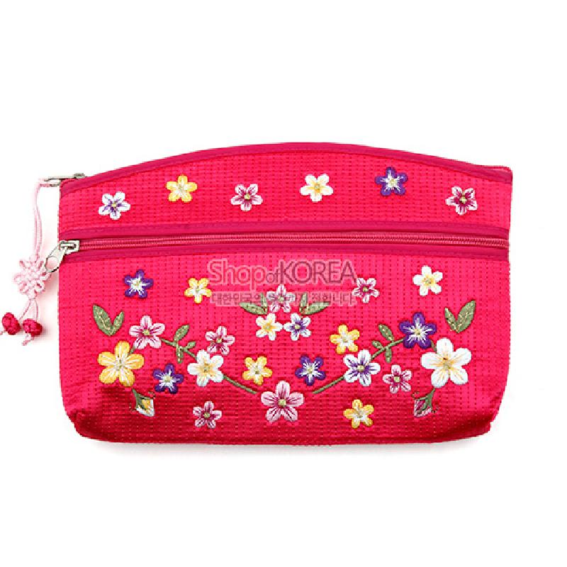 분홍색 비단 재질 위에 누비 기법으로 마감하고 다채로운 배꽃 자수 문양과 매듭 장식을 더한 파우치.